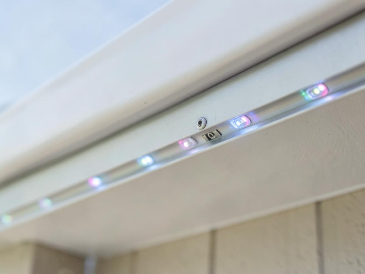 Close-up of the discreet aluminum channel and RGBW pixels mounted under a roofline